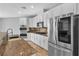 Modern kitchen featuring stainless steel appliances, granite countertops, and white cabinets at 5889 Taylor Valley Ave, Las Vegas, NV 89131