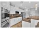 Modern kitchen features stainless steel appliances, granite countertops, and white cabinetry at 5889 Taylor Valley Ave, Las Vegas, NV 89131