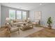 Bright living room features neutral décor, a cozy seating arrangement, and plenty of natural light at 5889 Taylor Valley Ave, Las Vegas, NV 89131