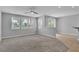 Open living room featuring plush carpeting, neutral walls, and large windows at 5889 Taylor Valley Ave, Las Vegas, NV 89131