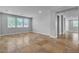 Open living room with tile flooring and an abundance of natural light from three large windows at 5889 Taylor Valley Ave, Las Vegas, NV 89131