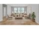 Bright living room features neutral décor, a cozy seating arrangement, and plenty of natural light at 5889 Taylor Valley Ave, Las Vegas, NV 89131