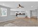 Bright and airy living room with a ceiling fan and an open floor plan to the kitchen at 5889 Taylor Valley Ave, Las Vegas, NV 89131