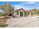 A large concrete patio leads to sliding glass doors of the neutral stucco single-story home at 5889 Taylor Valley Ave, Las Vegas, NV 89131