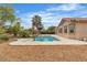 Backyard with pool, desert landscaping and a neutral stucco single-story home at 5889 Taylor Valley Ave, Las Vegas, NV 89131