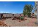 Landscaped backyard featuring gravel, brick accents, mature tree and shrubbery and a decorative fence at 621 Mount Elbert Way, Boulder City, NV 89005