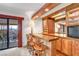 This well appointed home bar features wood cabinets, shelving, a mirrored backsplash and a lovely view at 621 Mount Elbert Way, Boulder City, NV 89005