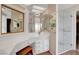 This bathroom boasts wallpapered walls, wood-look floors and a glass walled shower at 621 Mount Elbert Way, Boulder City, NV 89005
