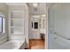 This brightly lit bathroom includes wood-look floors, a jetted tub and a glass walled shower at 621 Mount Elbert Way, Boulder City, NV 89005
