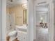This bathroom features wood-look floors, a shower-tub combo, a white vanity and plenty of natural light at 621 Mount Elbert Way, Boulder City, NV 89005