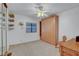 This bedroom has white walls, a ceiling fan, a closet with shelves, and a striking murphy bed at 621 Mount Elbert Way, Boulder City, NV 89005