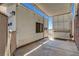 Exterior shot of a home featuring a carport with a utility sink and storage area along a brick wall at 621 Mount Elbert Way, Boulder City, NV 89005