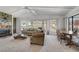 Cozy living room with a fireplace, an inviting seating area, and large windows for natural light at 621 Mount Elbert Way, Boulder City, NV 89005