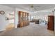 Bright living room with an accent cabinet, lots of natural light, and a view leading into the kitchen at 621 Mount Elbert Way, Boulder City, NV 89005