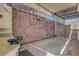 Enclosed back patio with a concrete floor, brick wall, and metal sheeting and decorative screening at 621 Mount Elbert Way, Boulder City, NV 89005