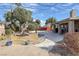 Beautiful backyard featuring mature trees, manicured landscaping, and a stone-lined path to the pool at 6308 Canyon Ridge Dr, Las Vegas, NV 89108