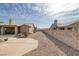 Large backyard featuring desert landscaping, block wall fencing for privacy, and a cozy covered patio at 6308 Canyon Ridge Dr, Las Vegas, NV 89108