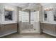 Spacious bathroom featuring dual vanities, stylish mirrors, and a large glass-enclosed shower at 6308 Canyon Ridge Dr, Las Vegas, NV 89108