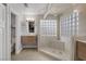Modern bathroom featuring a glass-enclosed shower with dual vanities and stylish fixtures at 6308 Canyon Ridge Dr, Las Vegas, NV 89108