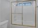 The bathroom features a shower-tub combo with sliding glass doors and white tile surround at 6308 Canyon Ridge Dr, Las Vegas, NV 89108