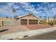 A house with a two-car garage, side yard access, and xeriscaping at 6308 Canyon Ridge Dr, Las Vegas, NV 89108