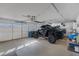 Spacious three car garage including attached opener and off-road recreational vehicles at 6308 Canyon Ridge Dr, Las Vegas, NV 89108