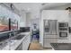 Bright kitchen with black marble countertops, stainless steel appliances, and a view into the dining area at 6308 Canyon Ridge Dr, Las Vegas, NV 89108