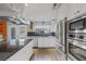 Kitchen featuring an island, stainless appliances, lots of cabinets, and a view of the sink and backyard at 6308 Canyon Ridge Dr, Las Vegas, NV 89108