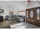 The living room is showcasing a sectional and bright, natural light through a large window at 6308 Canyon Ridge Dr, Las Vegas, NV 89108