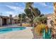 Picturesque backyard pool with lush landscaping and a spacious concrete deck for ultimate relaxation at 6308 Canyon Ridge Dr, Las Vegas, NV 89108