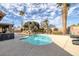 Relaxing backyard pool with a spacious deck, complemented by mature trees and desert landscaping at 6308 Canyon Ridge Dr, Las Vegas, NV 89108