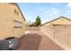 Property featuring a gravel backyard, walled perimeter, air conditioner, and rear window at 6512 N Bruce St, North Las Vegas, NV 89086
