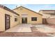 The backyard of this property featuring a patio, gravel yard, door and windows at 6512 N Bruce St, North Las Vegas, NV 89086
