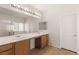 Bathroom featuring double sinks, large mirror, and decorative lighting at 6512 N Bruce St, North Las Vegas, NV 89086