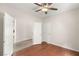 Bedroom with wood floors, ceiling fan, view into the hallway and an exterior door at 6512 N Bruce St, North Las Vegas, NV 89086
