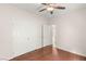 Bedroom with wood floors, ceiling fan, closet, and a view into the hallway at 6512 N Bruce St, North Las Vegas, NV 89086