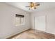 A bright bedroom showcasing stained concrete floors, natural light, and a spacious double-door closet at 6512 N Bruce St, North Las Vegas, NV 89086