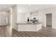 Open kitchen with a large center island and stainless steel appliances at 6512 N Bruce St, North Las Vegas, NV 89086