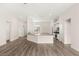 Open floor plan with white kitchen cabinets and center island with bar seating at 6512 N Bruce St, North Las Vegas, NV 89086