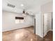 An open-concept living room with stained concrete floors, ceiling fan, and natural light from the window at 6512 N Bruce St, North Las Vegas, NV 89086