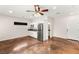 Open floor plan with stainless steel refrigerator, concrete flooring, and white cabinets with a ceiling fan at 6512 N Bruce St, North Las Vegas, NV 89086