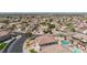 Panoramic aerial view showcasing a residential neighborhood with pools, desert landscaping, and city skyline backdrop at 6638 Dazzling Heights Ln, Las Vegas, NV 89110