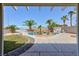 Covered patio overlooks a beautiful pool surrounded by mature palms at 6638 Dazzling Heights Ln, Las Vegas, NV 89110