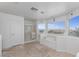 Bright bathroom with a bathtub, shower, and expansive windows overlooking the landscape at 6638 Dazzling Heights Ln, Las Vegas, NV 89110