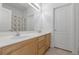 Well-lit bathroom with double sinks, and a large mirror at 6638 Dazzling Heights Ln, Las Vegas, NV 89110