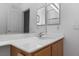 Bright bathroom showcasing a white countertop and a wooden vanity with sink at 6638 Dazzling Heights Ln, Las Vegas, NV 89110