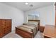 Bedroom with natural lighting, well-made bed, and wooden dresser at 6638 Dazzling Heights Ln, Las Vegas, NV 89110