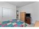 A bedroom with light walls, carpet, closet with sliding doors, and a TV at 6638 Dazzling Heights Ln, Las Vegas, NV 89110