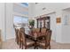 Elegant dining room with seating for eight, a chandelier, and large windows for natural light at 6638 Dazzling Heights Ln, Las Vegas, NV 89110