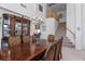 Formal dining area with hardwood table, carved chairs, and a decorative chandelier at 6638 Dazzling Heights Ln, Las Vegas, NV 89110